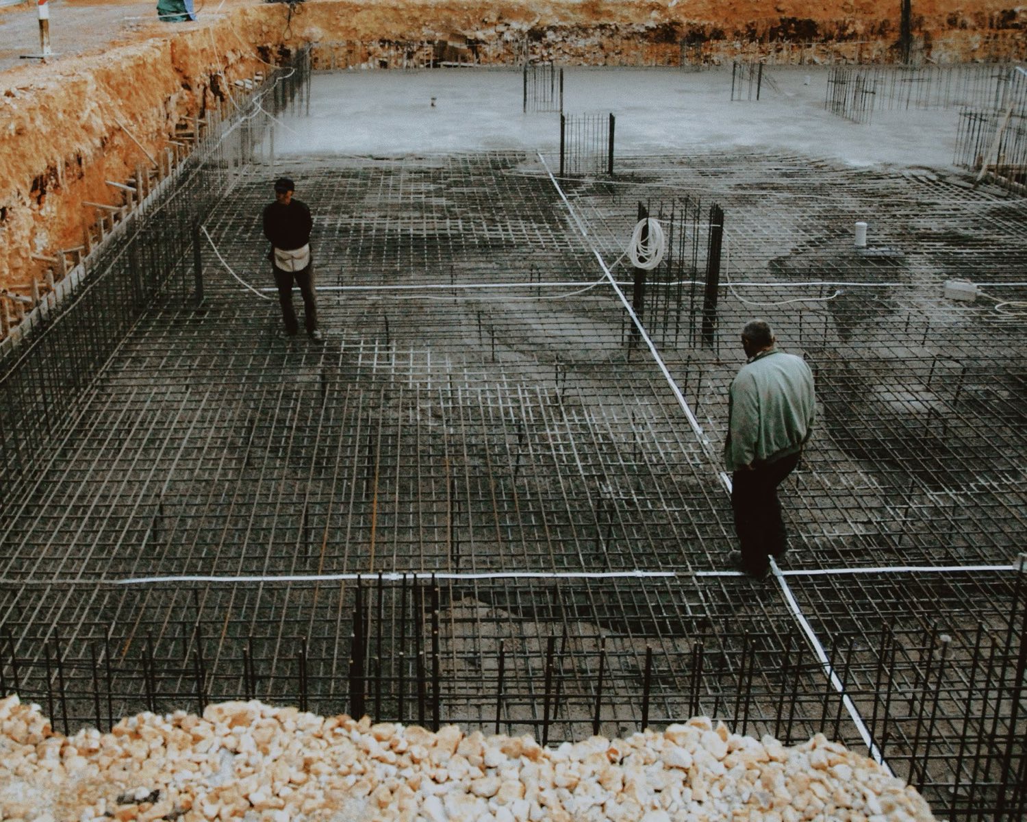 Reinforcing steel grid laid across a slab excavation before the pour